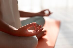 Close-up of a person meditating in a sunny room