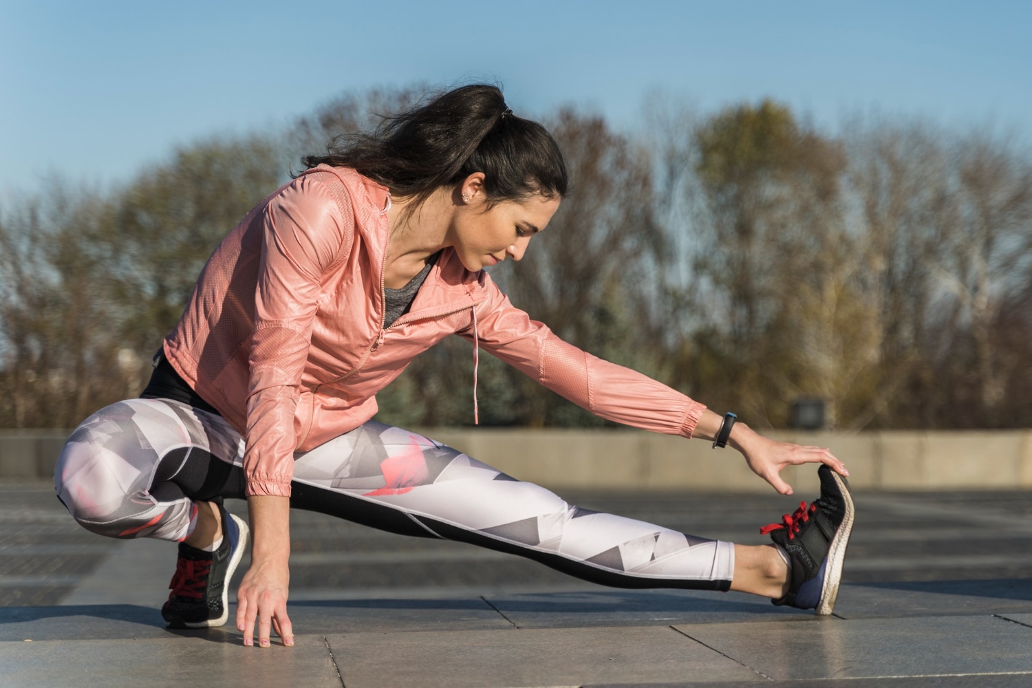 woman stretches her leg forward on a sunny day