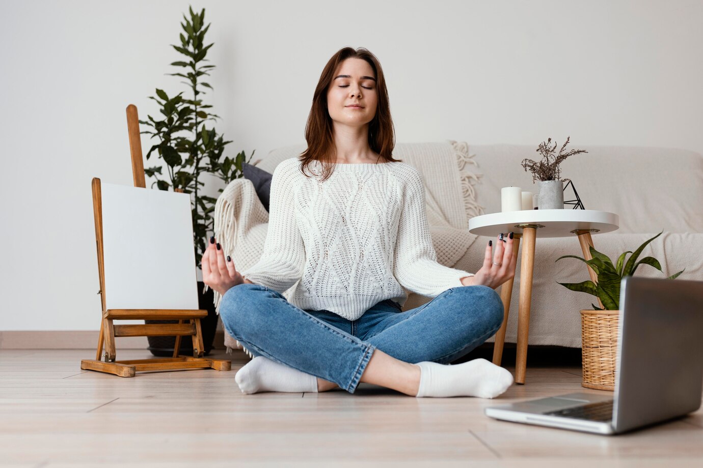 A young woman meditating in a peaceful indoor setting