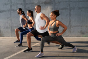 people performing lunges together in an outdoor setting