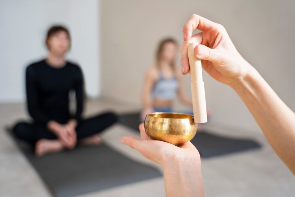 person's hands holding a Tibetan singing bowl