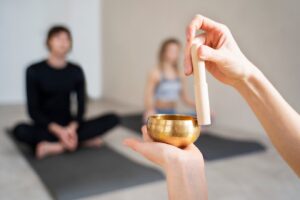 person's hands holding a Tibetan singing bowl