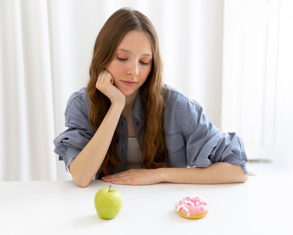 young woman in a denim shirt sitting at a table